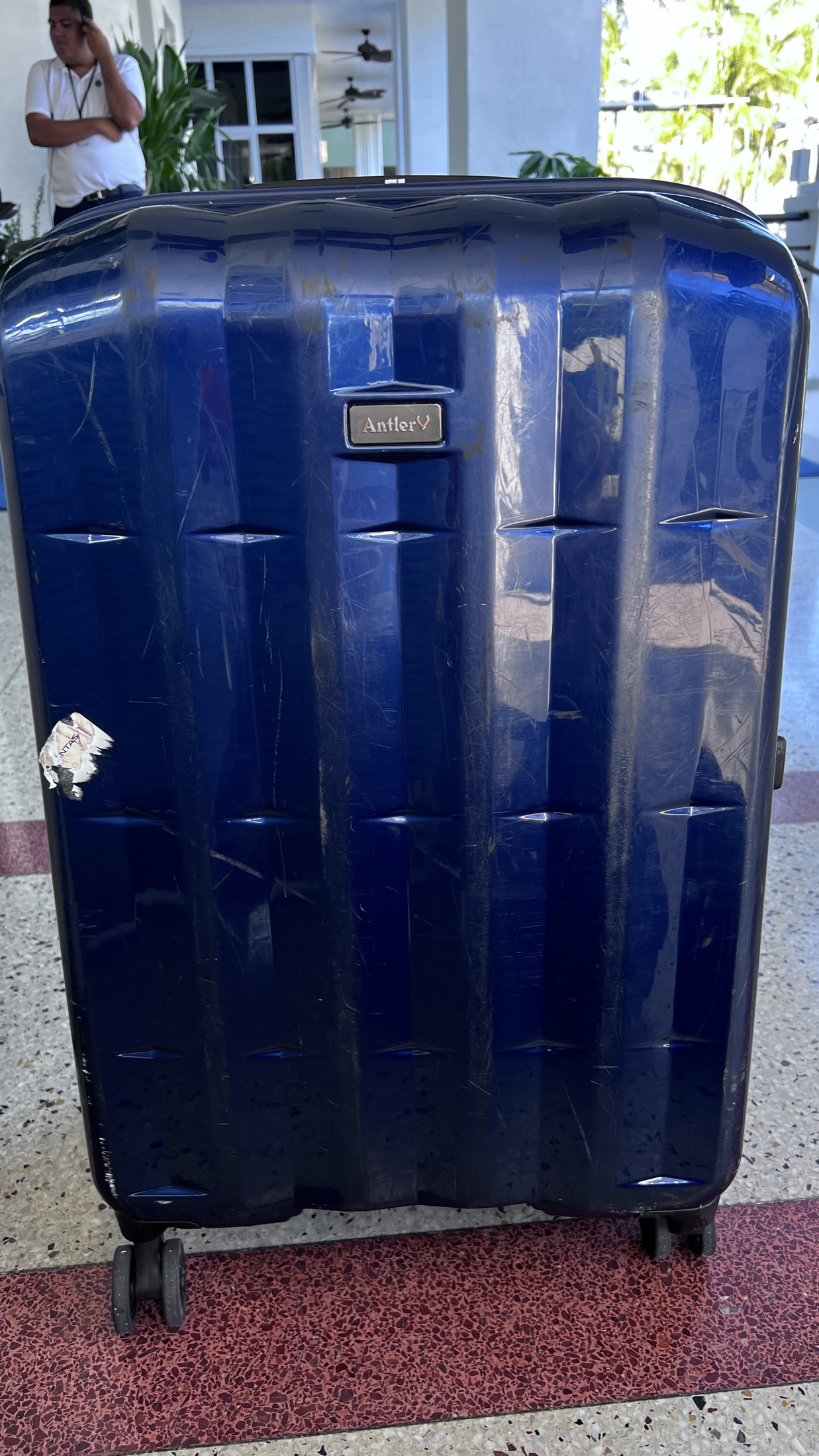 Scratched checked suitcase